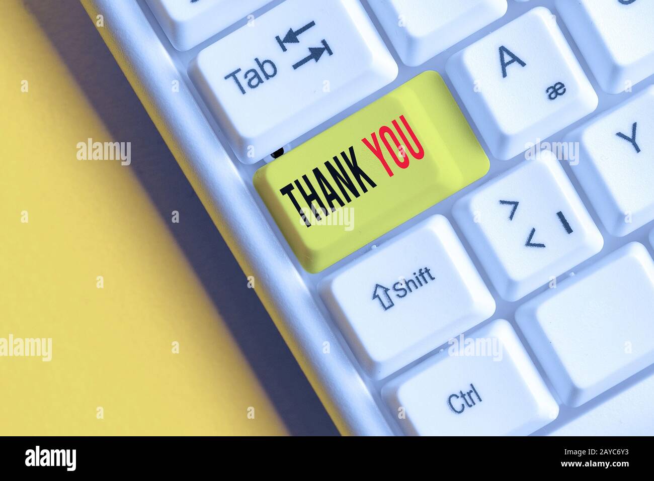 Handwriting text writing Thank You. Concept meaning a polite expression used when acknowledging a gift or service White pc keybo Stock Photo