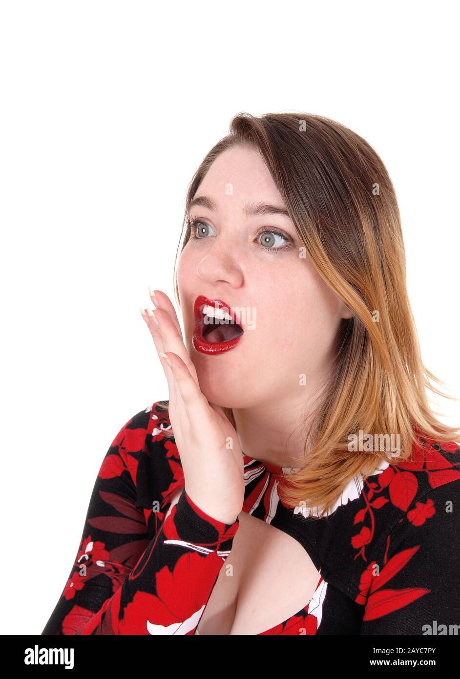 Young woman holding hand over her mouths Stock Photo