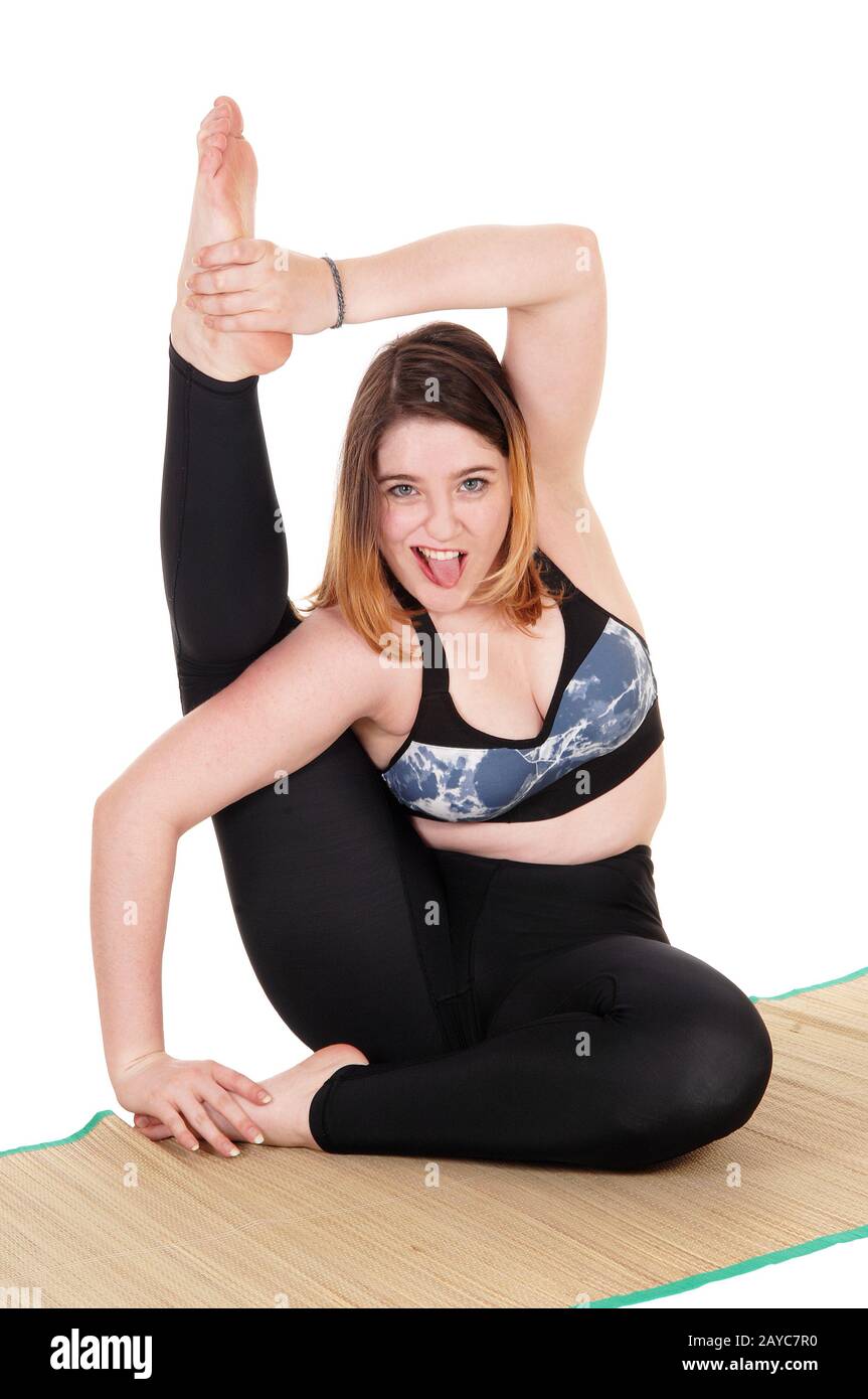 Exercising young woman sitting on the floor Stock Photo - Alamy