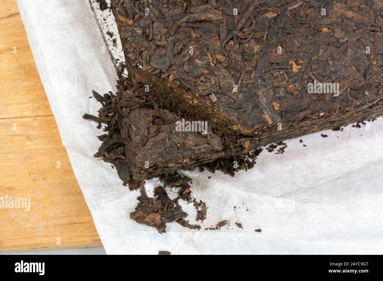 Chinese Yunnan Pu Erh tea block wrapped in white silk paper Stock Photo