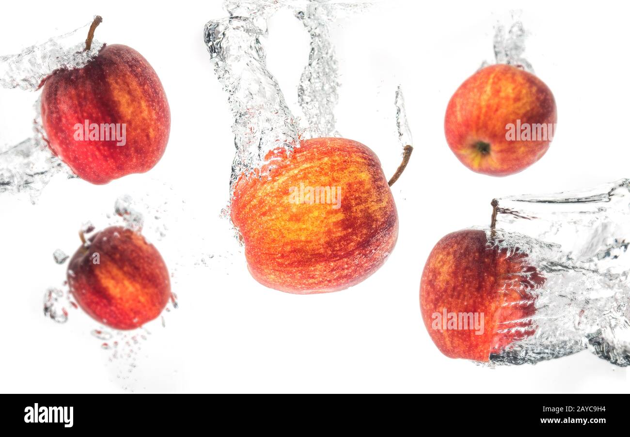 Apples falling under water with a splash. Background Stock Photo