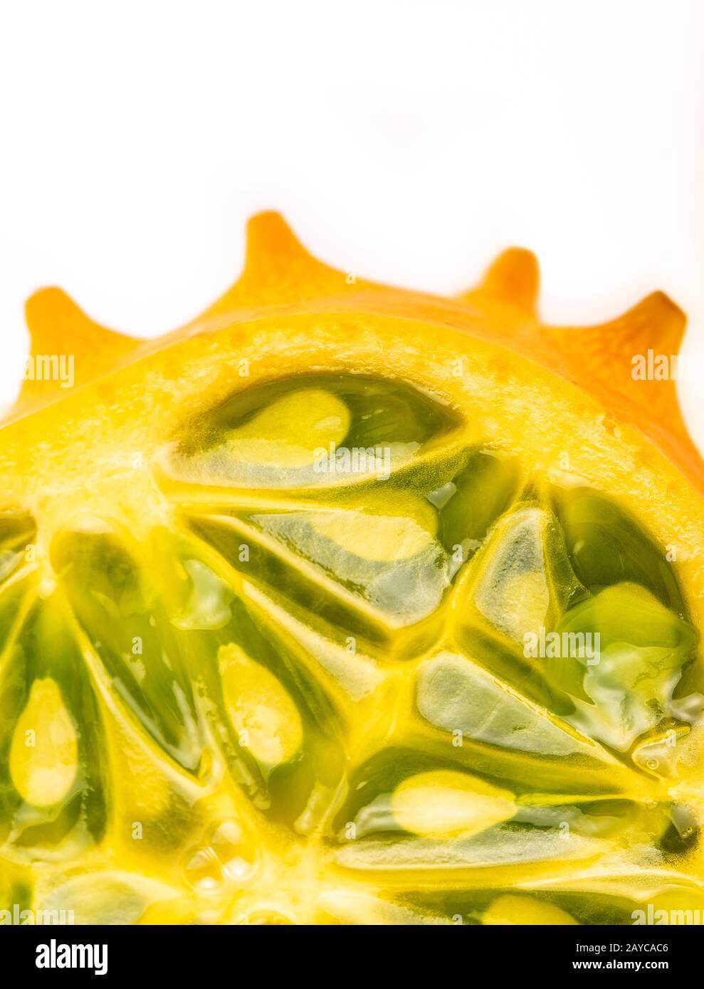 Kiwano or Horned Melon (Cucumis metuliferus) sliced in a half on white