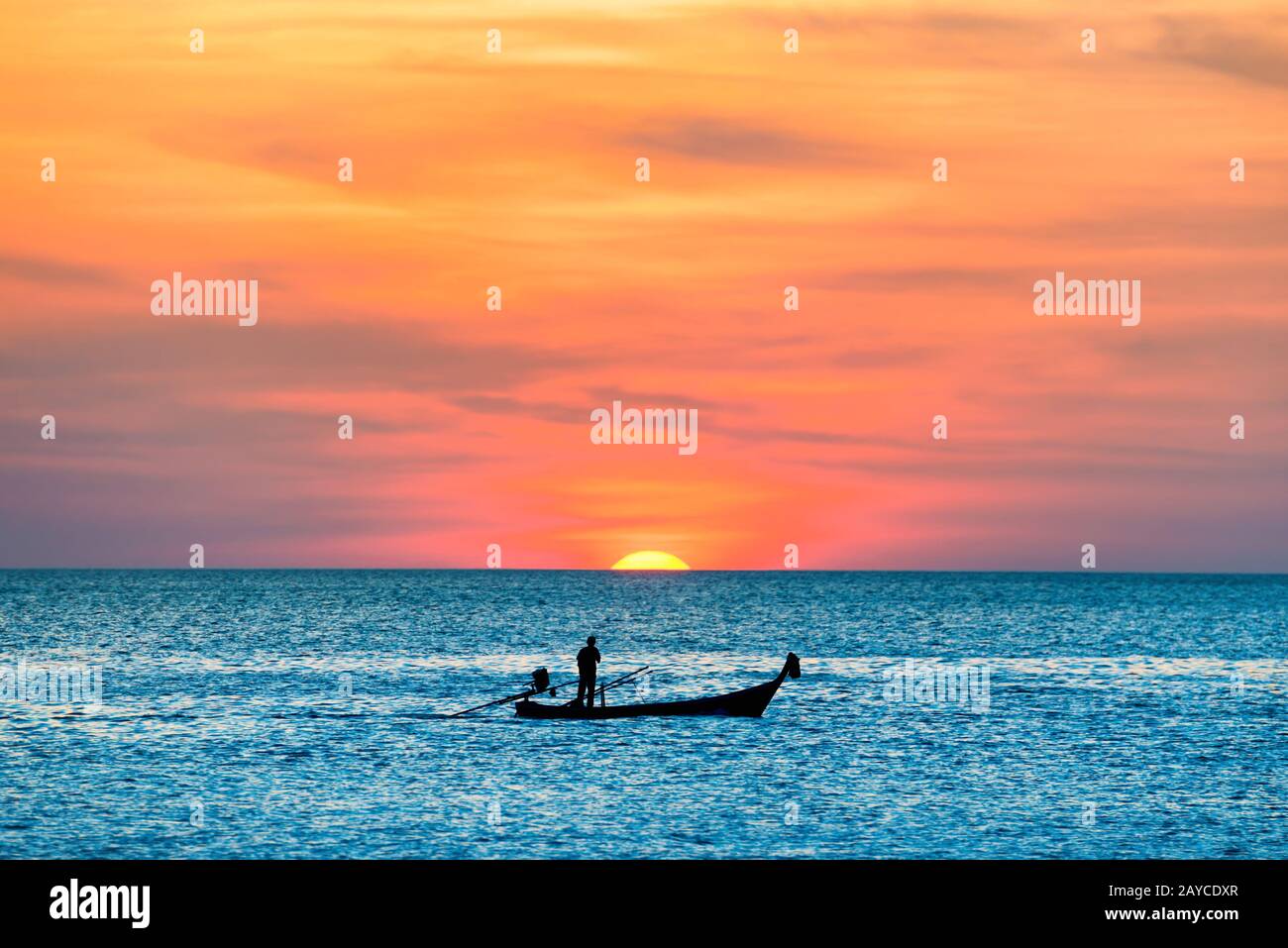 Fishing boat in sea at sunset Stock Photo - Alamy