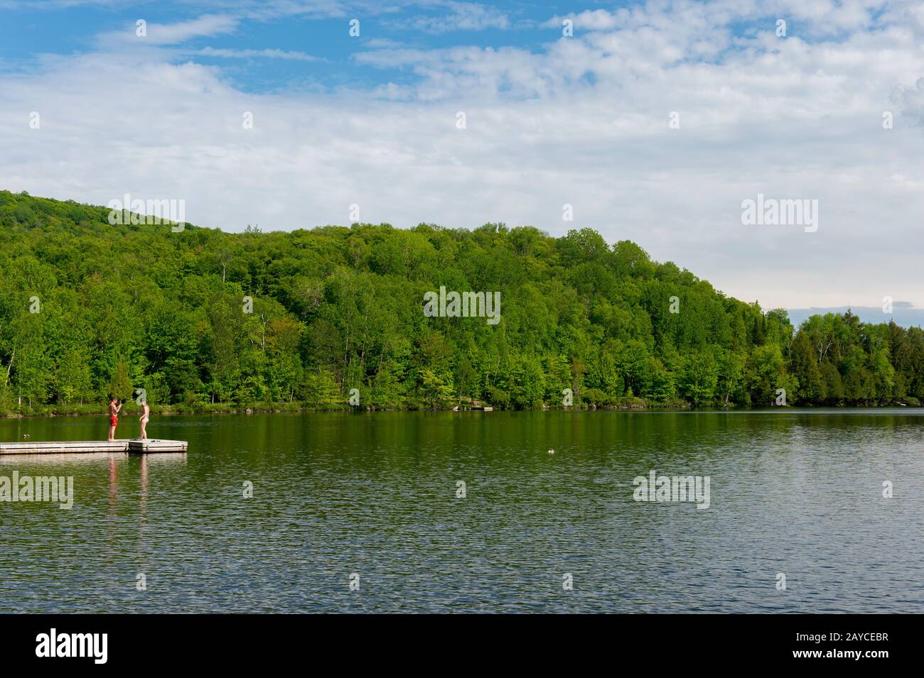 People on a dock in Lac Mercier from the Le Petit Train du Nord Bike
