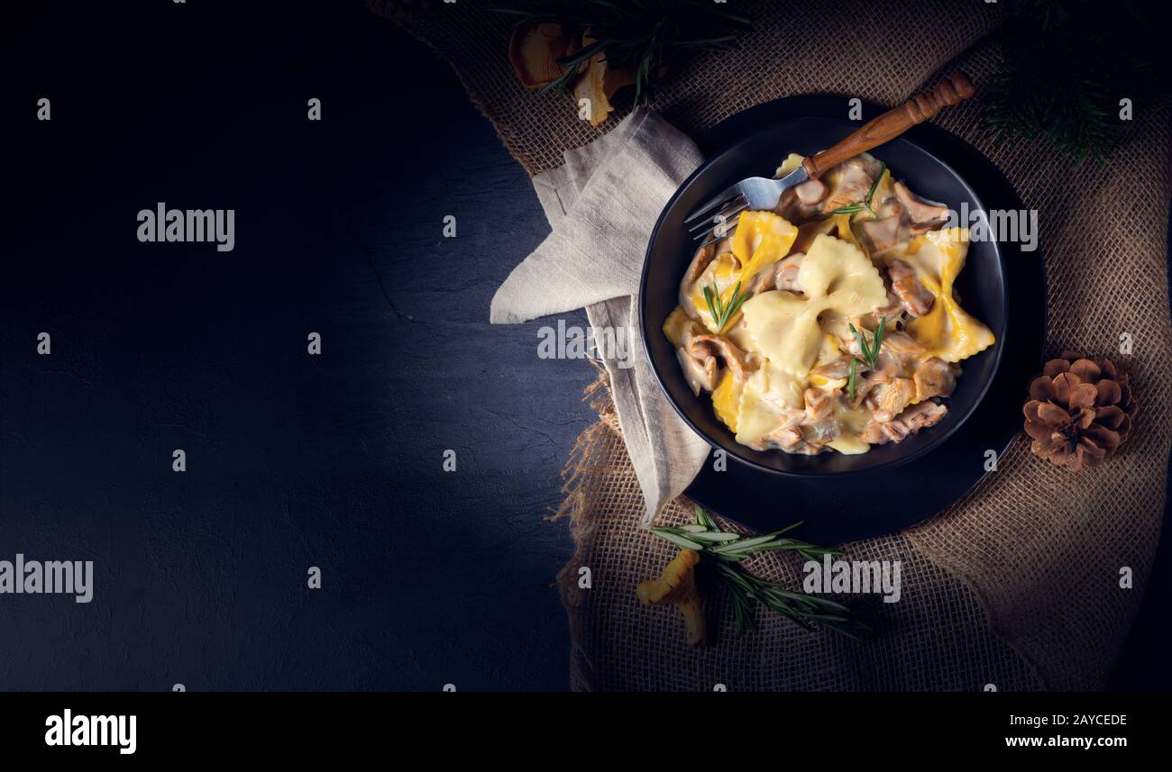 Colorful farfalle pasta with chanterelles and cream sauce Stock Photo