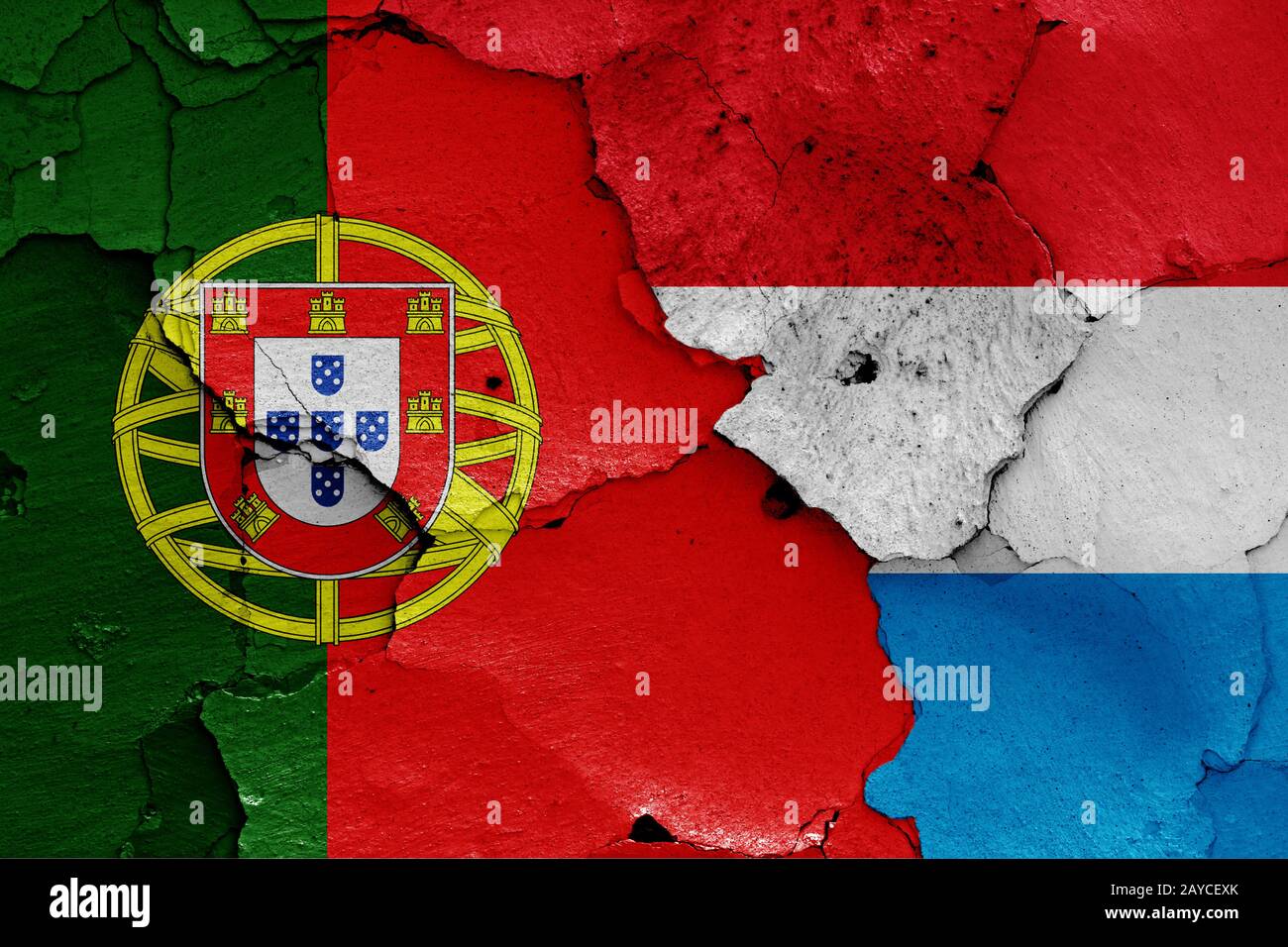 flags of Portugal and Luxembourg painted on cracked wall Stock Photo