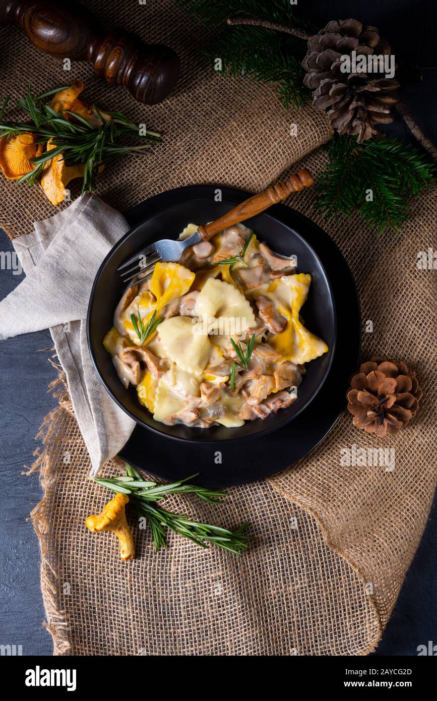 Colorful farfalle pasta with chanterelles and cream sauce Stock Photo