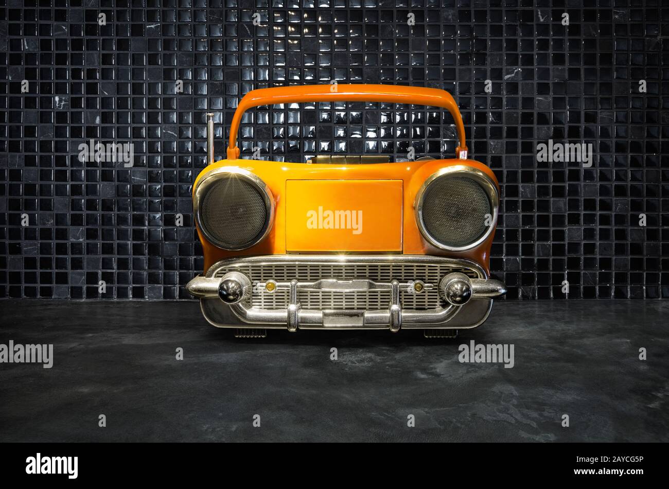 Old antique car shape AM FM stereo cassette player on mosaic tiles background Stock Photo
