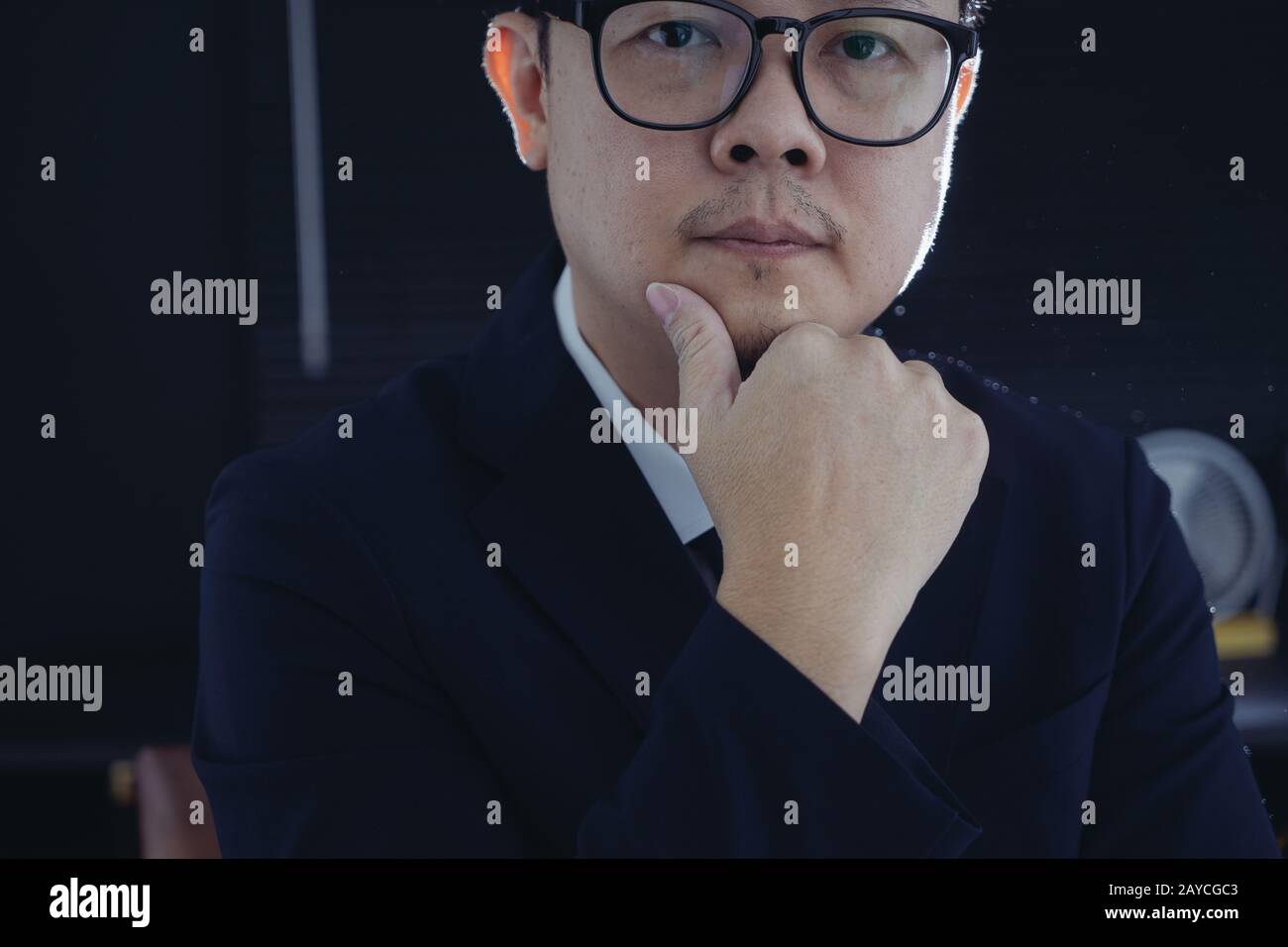 Smart businessman in suit and eyeglasses looking at camera . Closeup view . Stock Photo