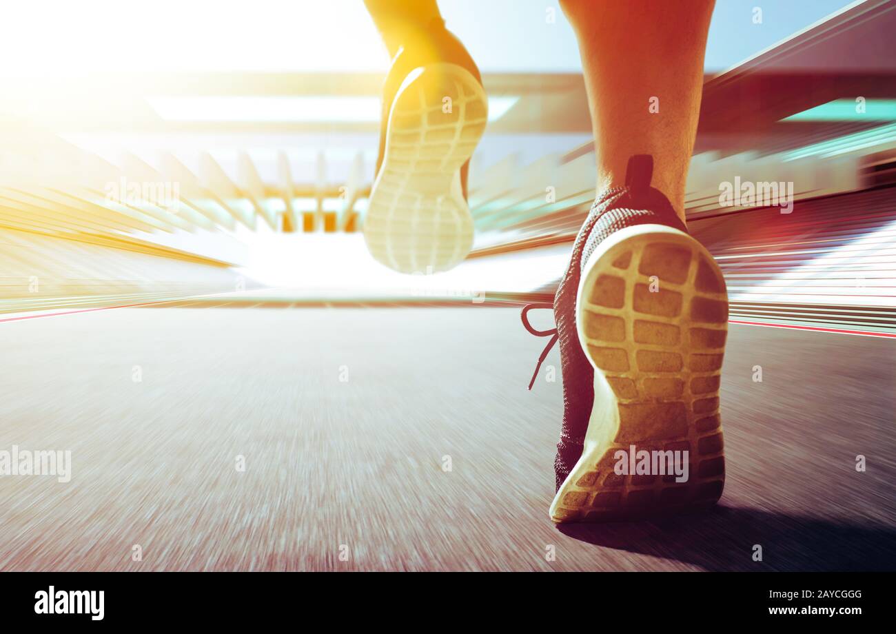 Close up of runner legs run on the stadium . Stock Photo