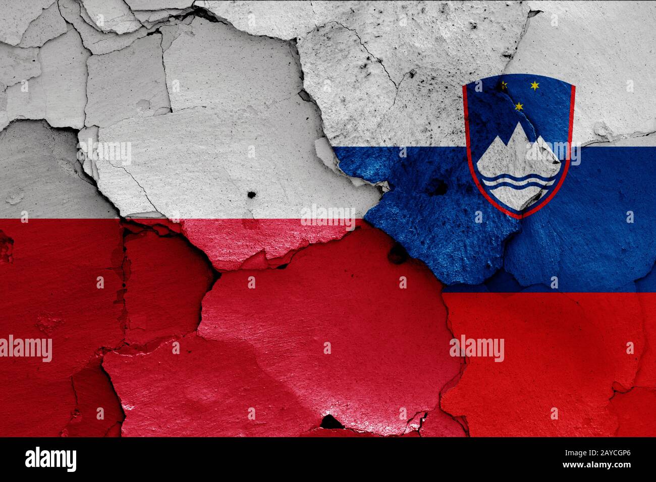 flags of Poland and Slovenia painted on cracked wall Stock Photo