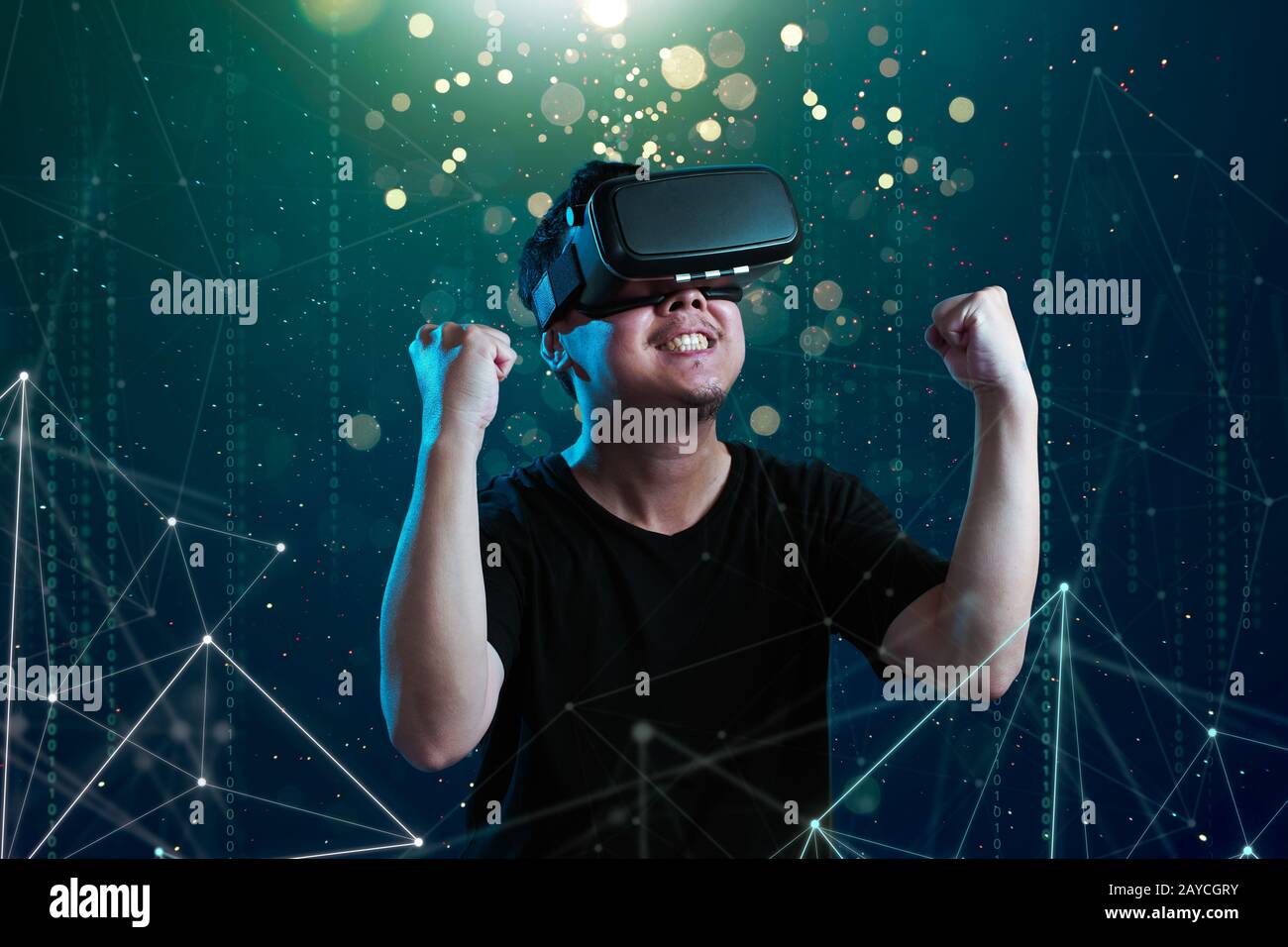 Asian man wearing virtual reality goggles in cyberspace imaging. Stock Photo