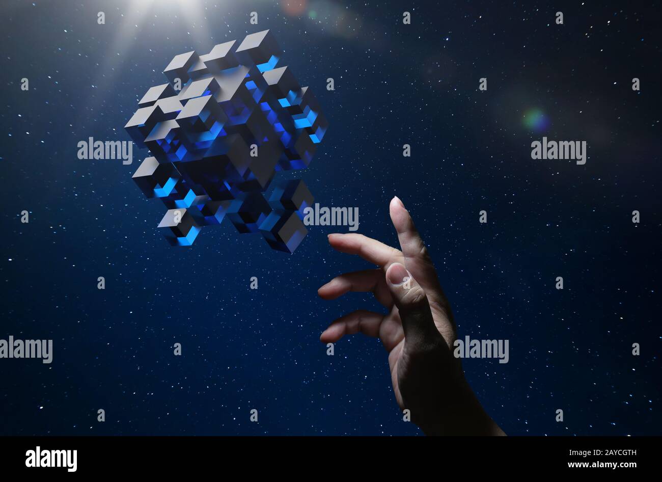 Unknown hand touching floating blue shiny cube on dark background . Stock Photo