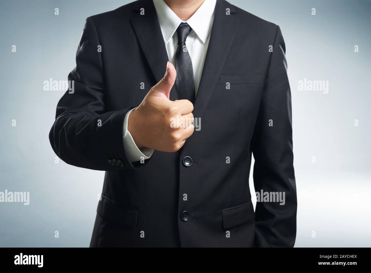 Successful businessman gives thumb up  style. Likes and positive feel. Gesture good and agree Stock Photo