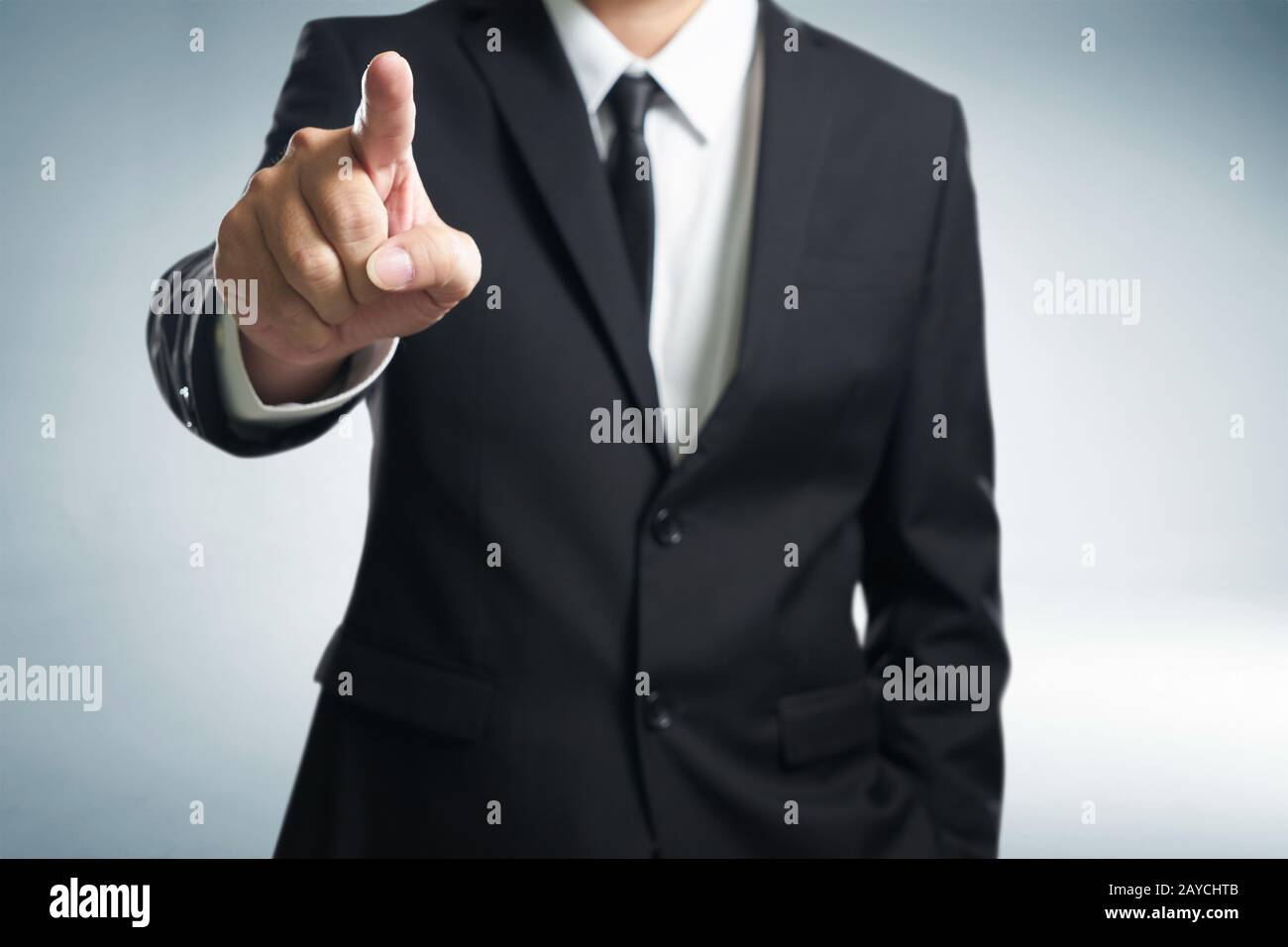 Business man points his finger at you . (focus on hand Stock Photo