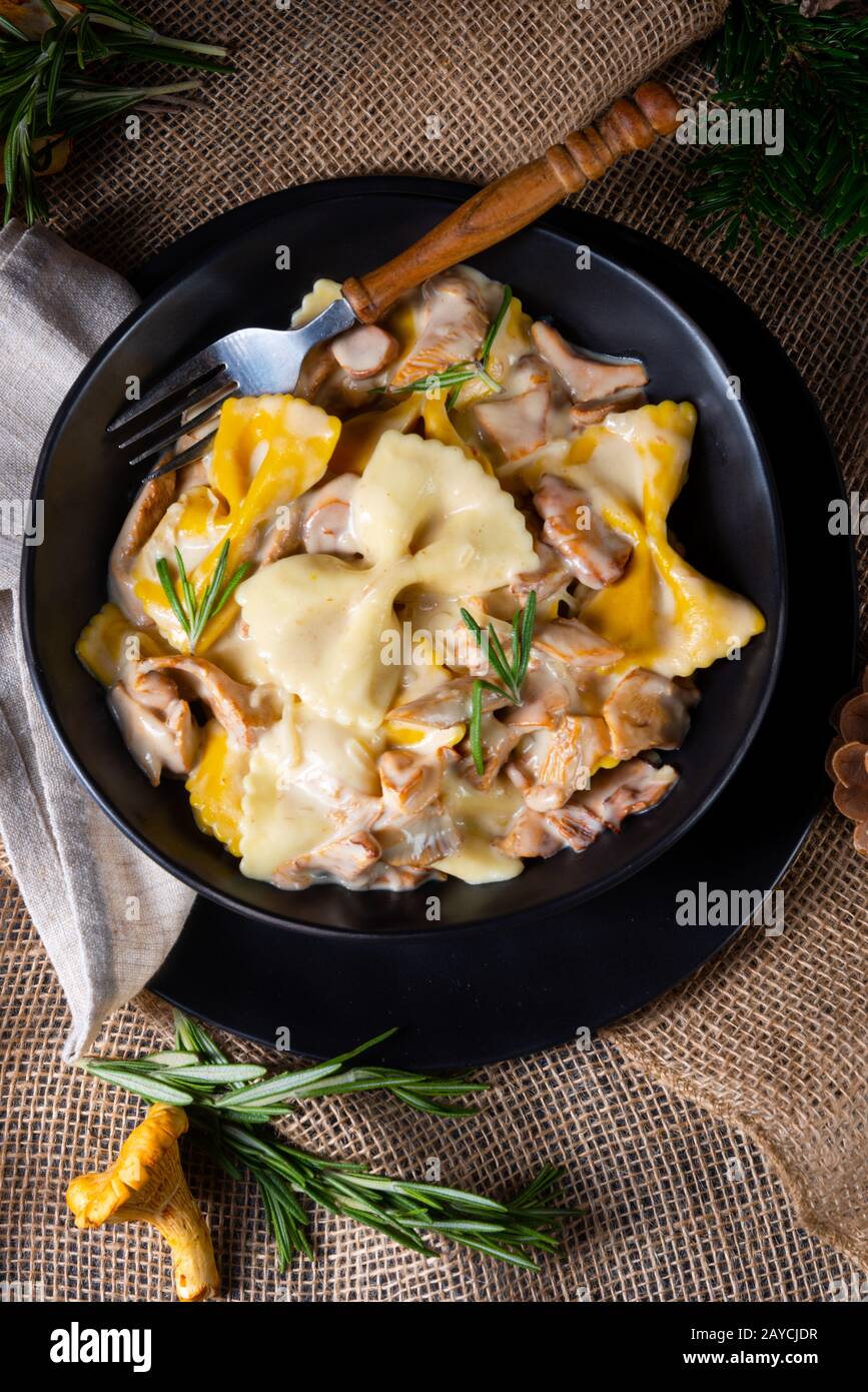 Colorful farfalle pasta with chanterelles and cream sauce Stock Photo