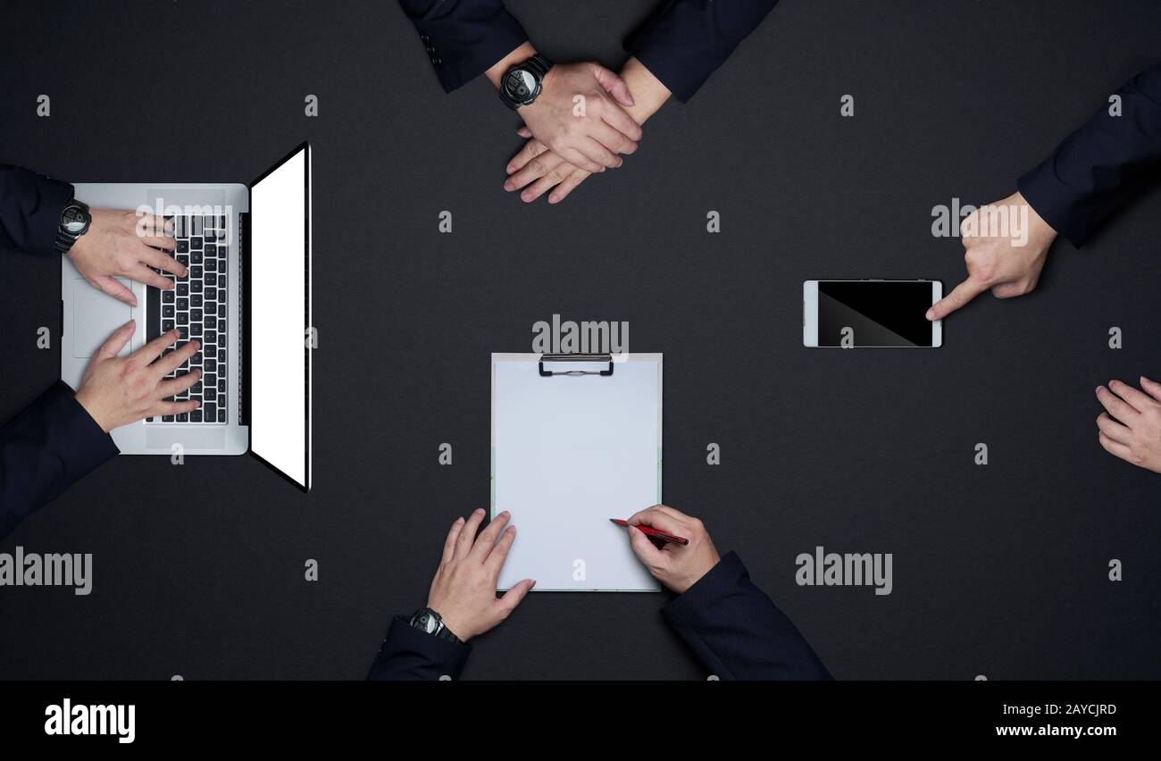 Group of business people working together . Flat lay and top view with copy space on black background .Business brainstorming me Stock Photo