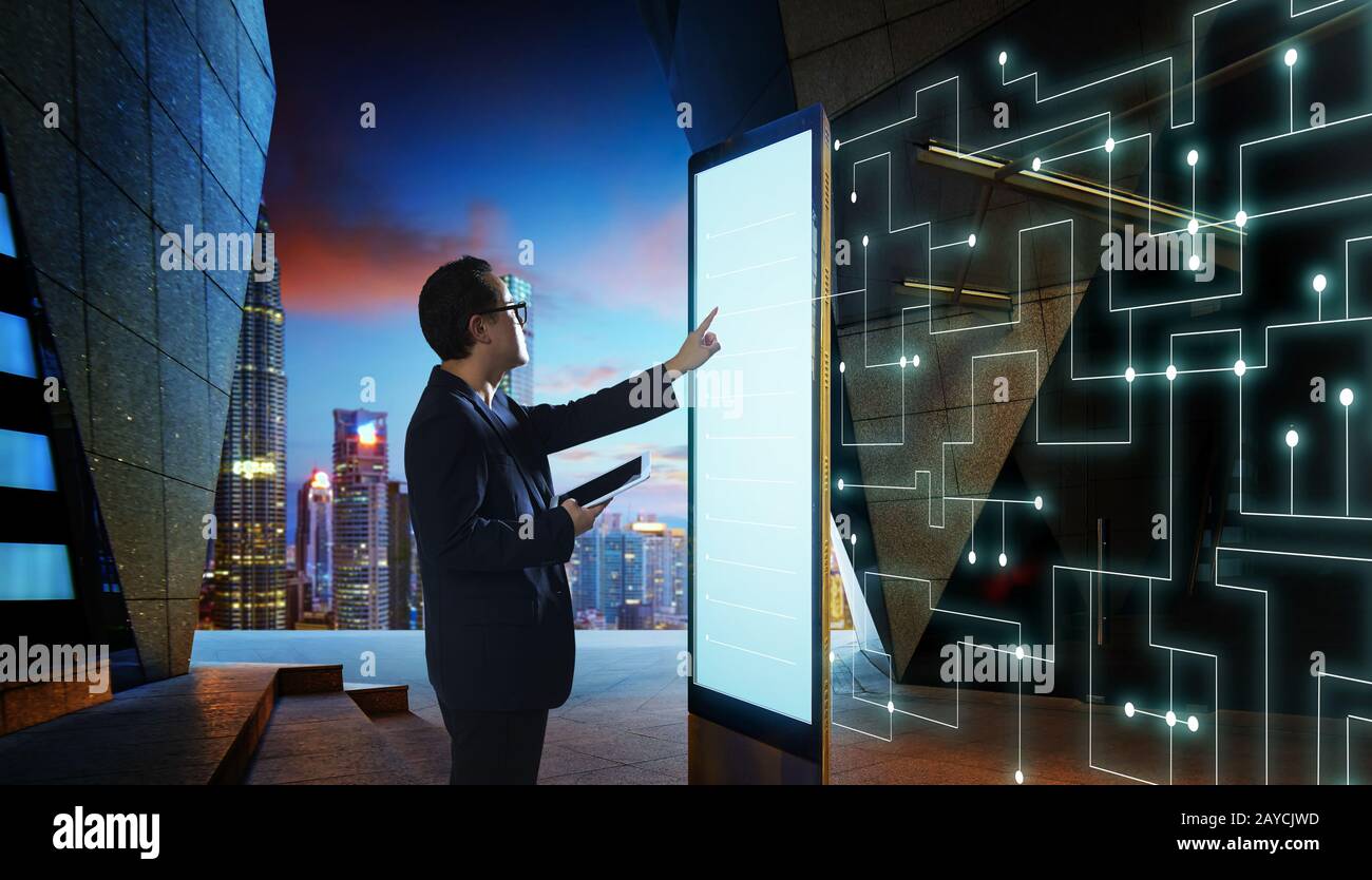 Smart businessman touch the screen to search the information of intelligent communication network of things . Night scene with m Stock Photo