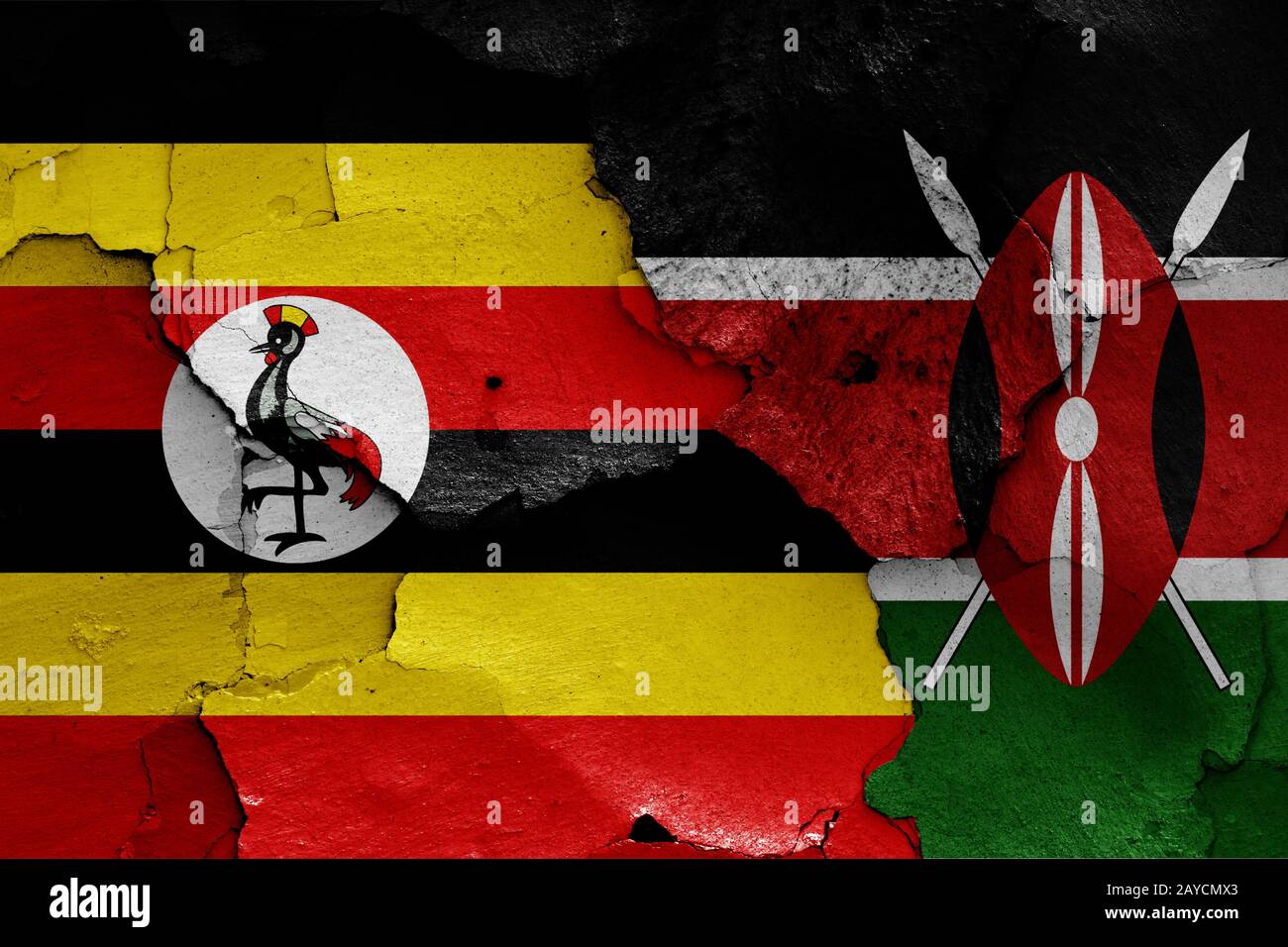 flags of Uganda and Kenya painted on cracked wall Stock Photo