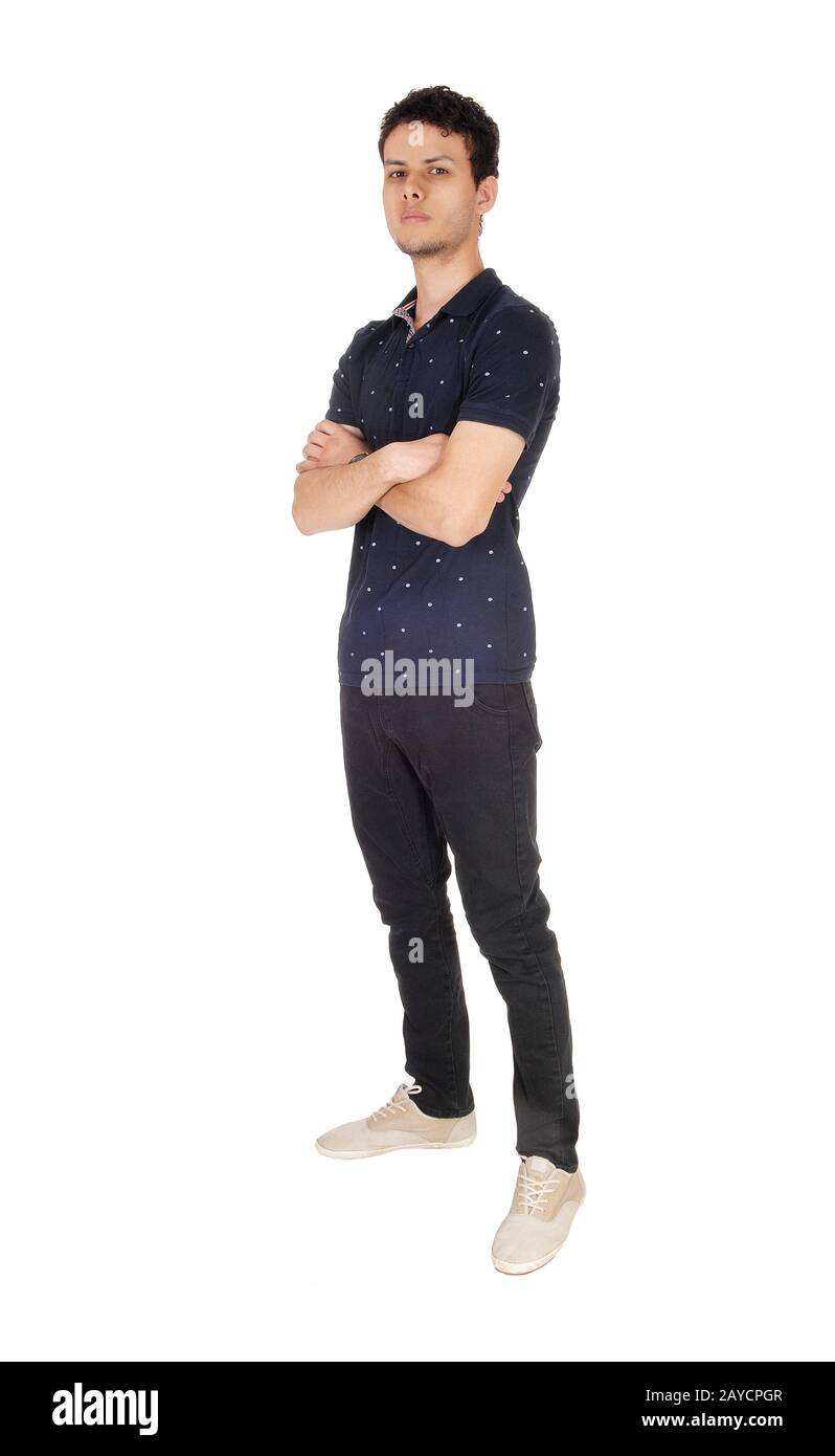 Tall young man standing with his arms crossed Stock Photo