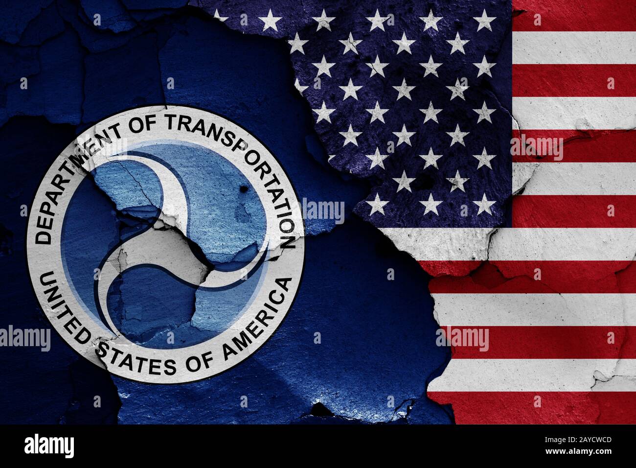 flags of Department of Transportation and USA painted on cracked wall Stock Photo