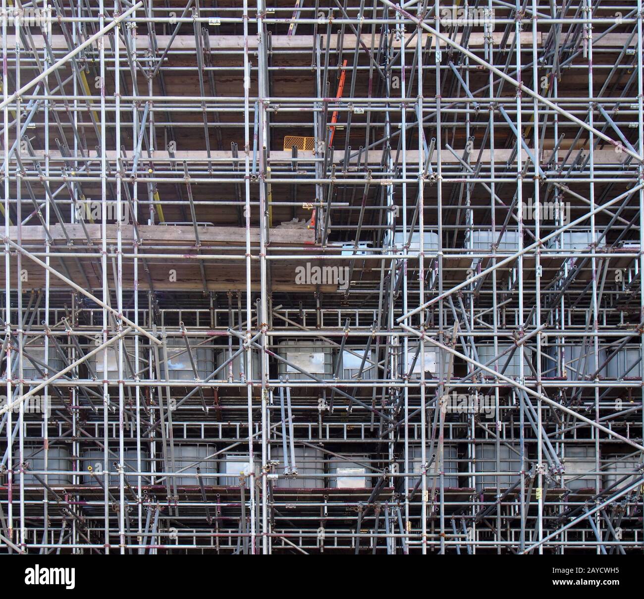 a full frame image of a network of scaffolding covering a large building under renovation Stock Photo