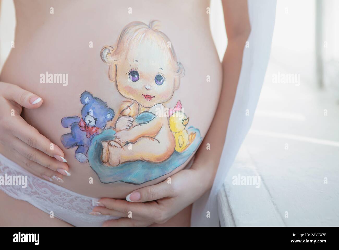 Beautiful drawing on the stomach of a pregnant woman Stock Photo