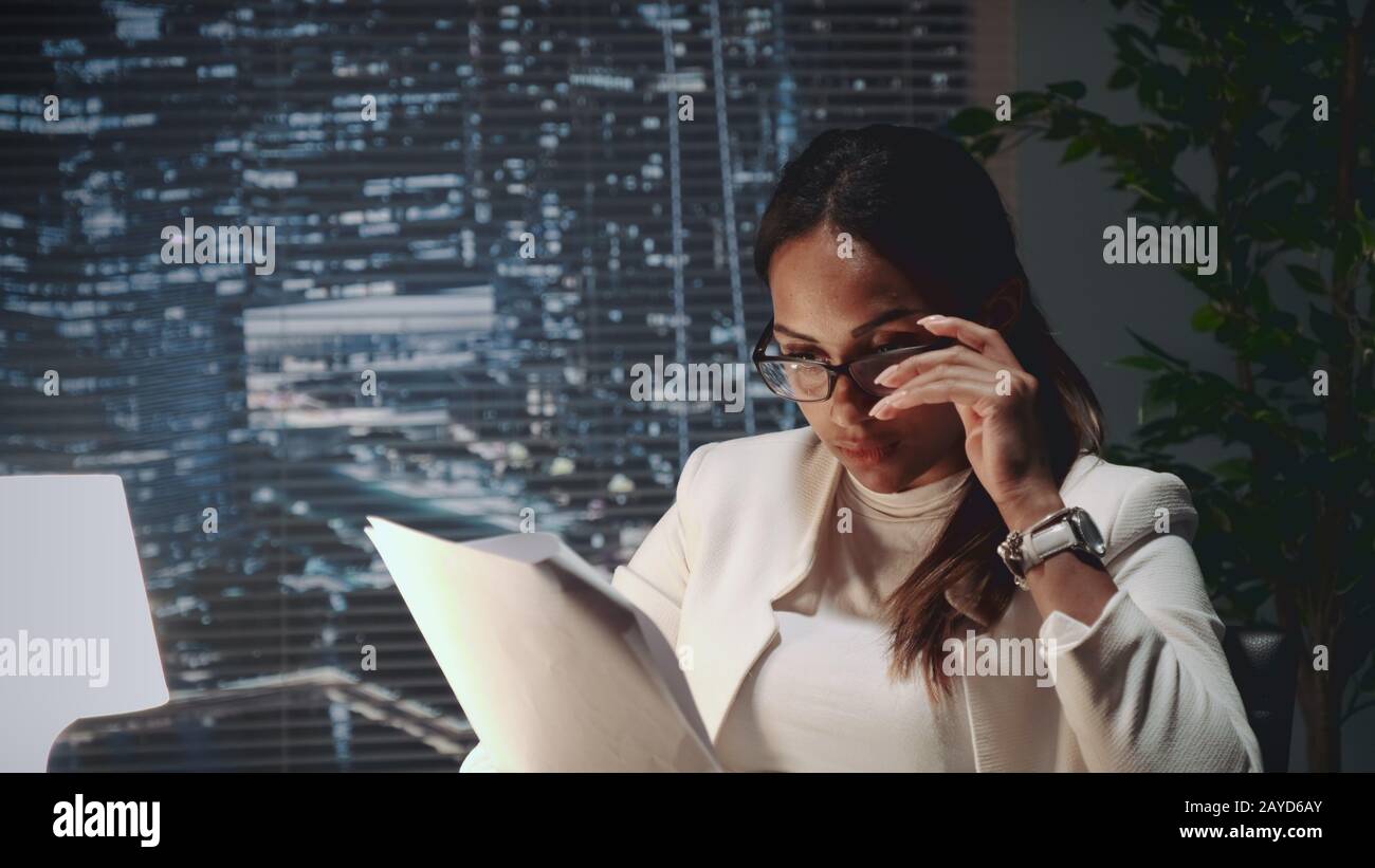 African american business woman in eyeglasses reading document at the ...
