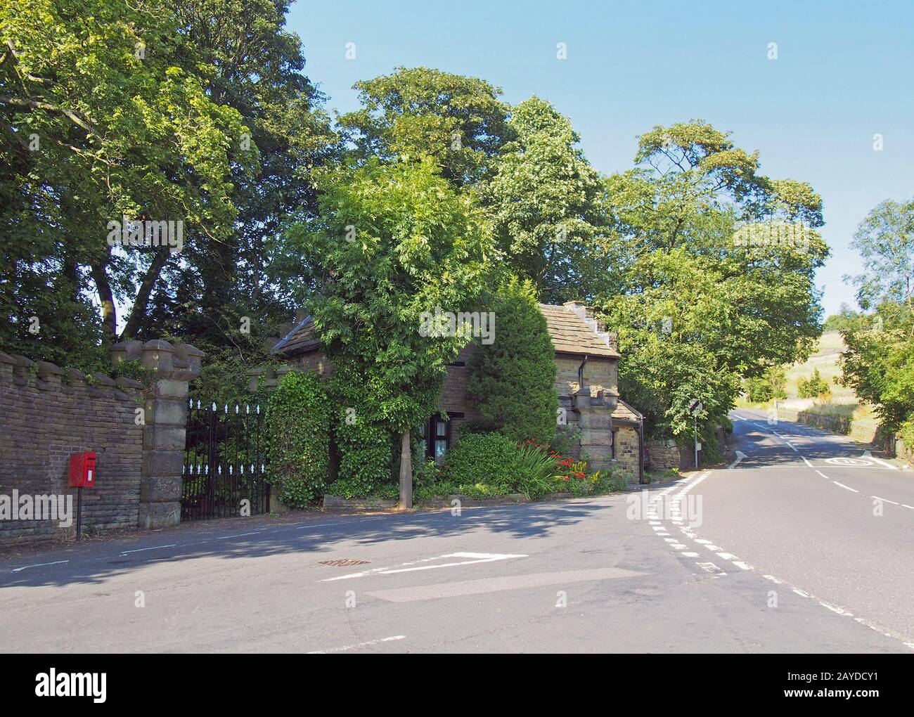 a roadside view of houses and trees in the small west yorkshire village