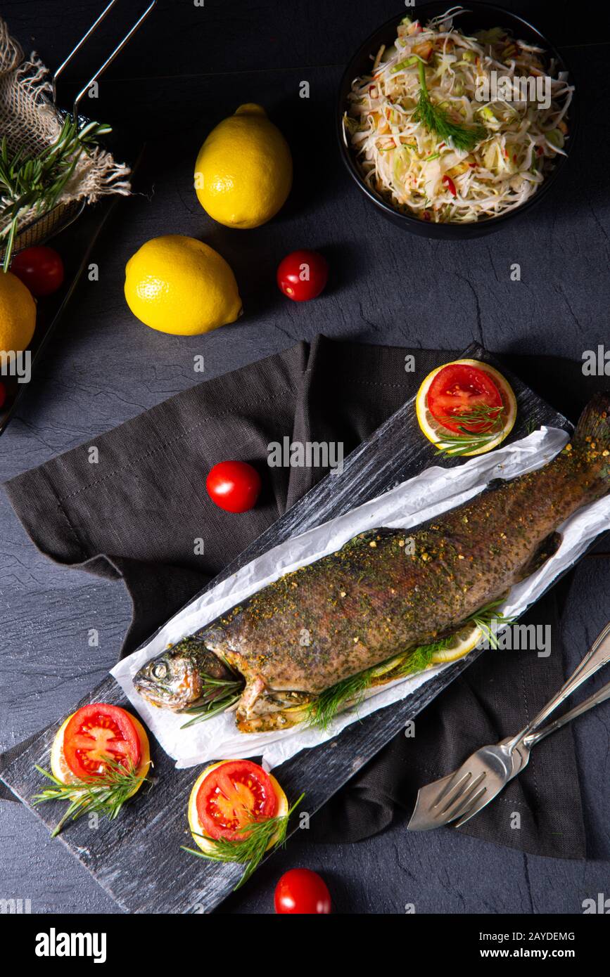 baked trout with herb filling and tomatoes Stock Photo - Alamy