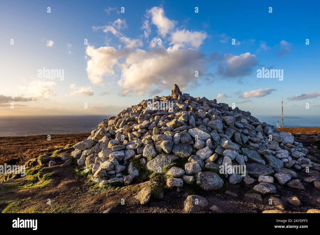 Sunset at Ticknock hill in Wicklow mountains with pile of stones, golden hour, Ireland Stock Photo