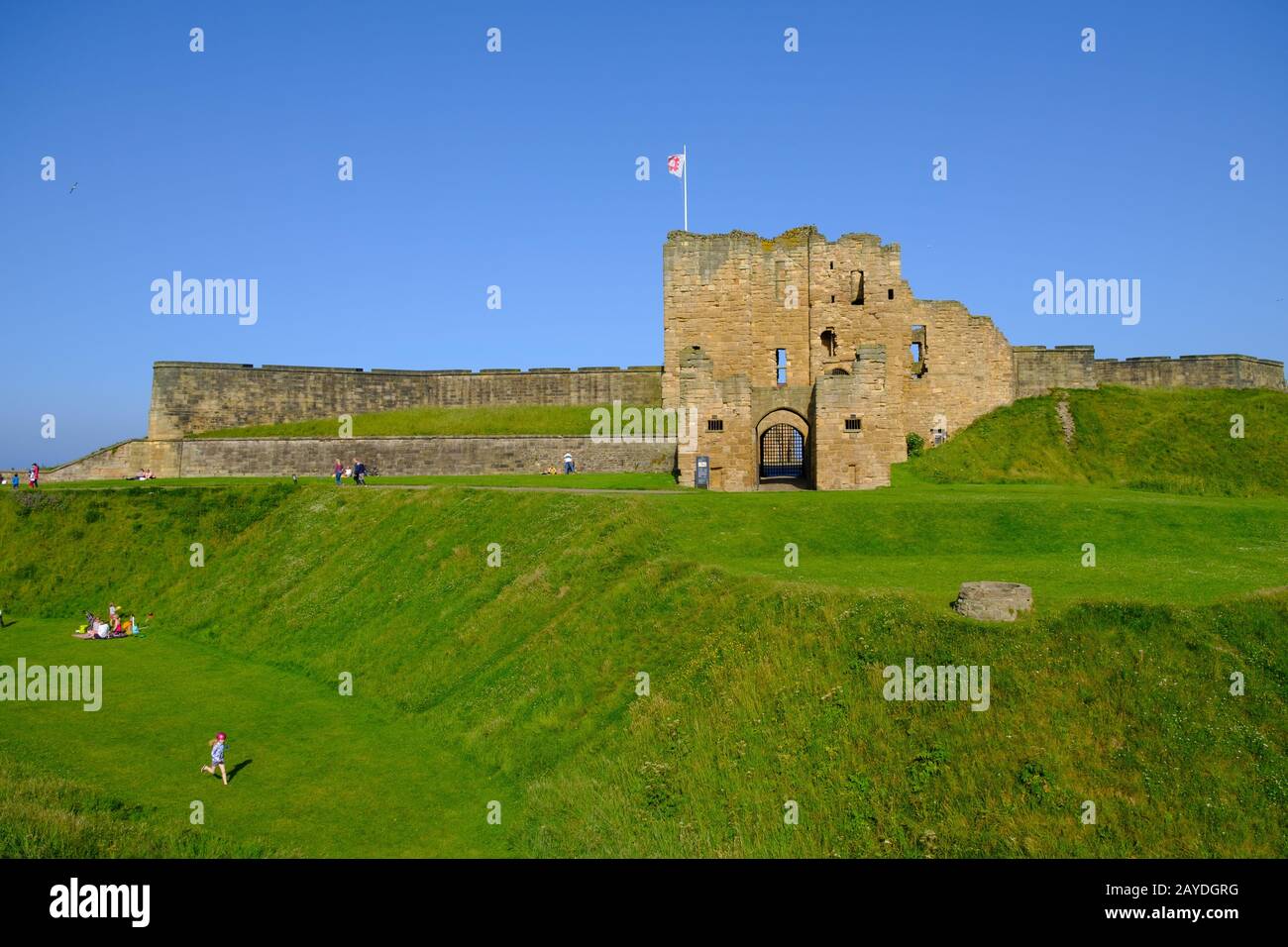 People enjoy themselves at the Tynemouth Priory and Castle on a beautiful sunny summer afternoon. Stock Photo