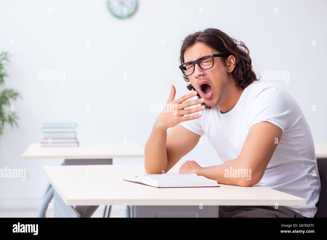 Young male student sitting in the classroom Stock Photo - Alamy