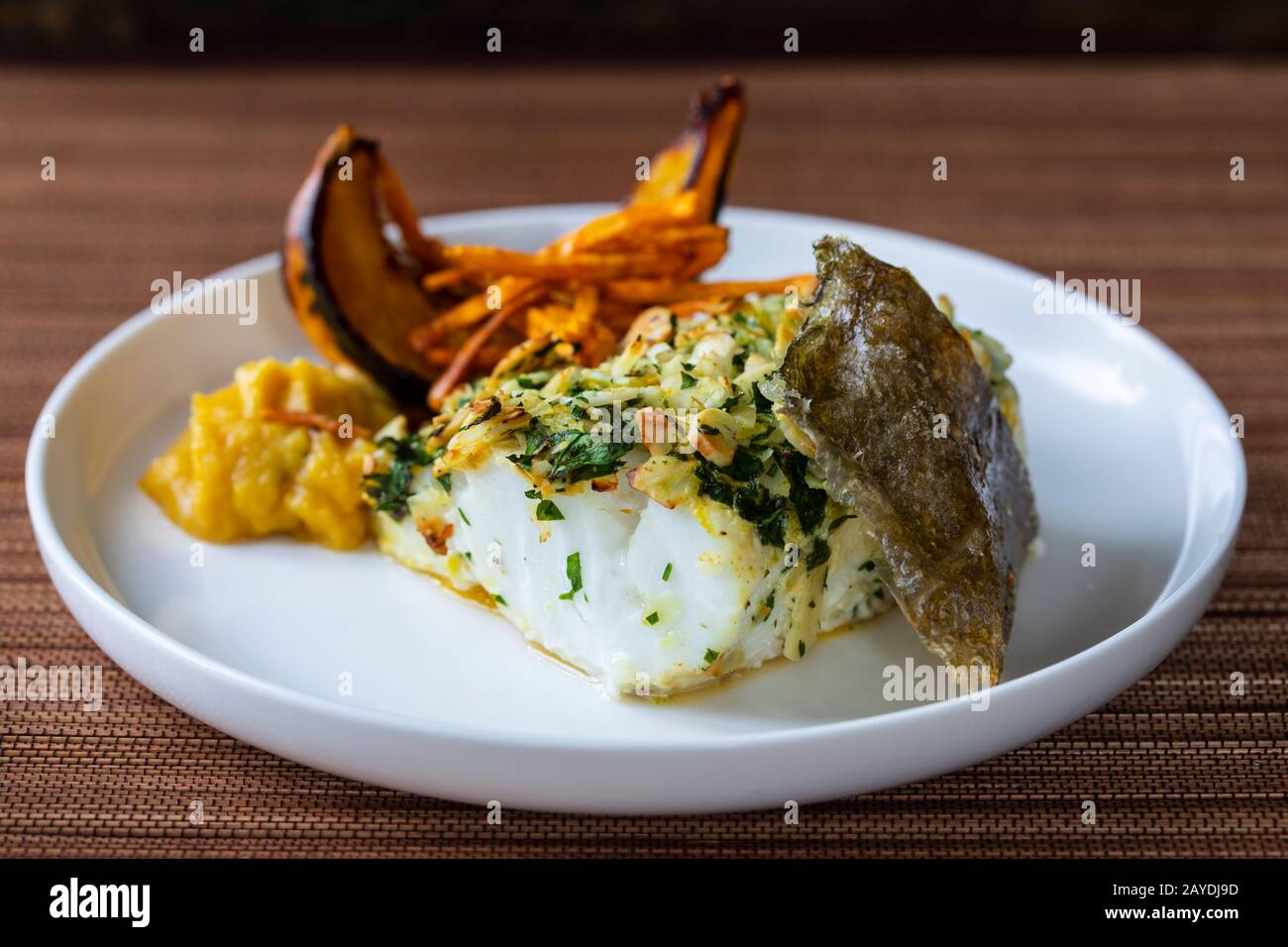 Cod loin in almond crust with pumpkin and fennel Stock Photo