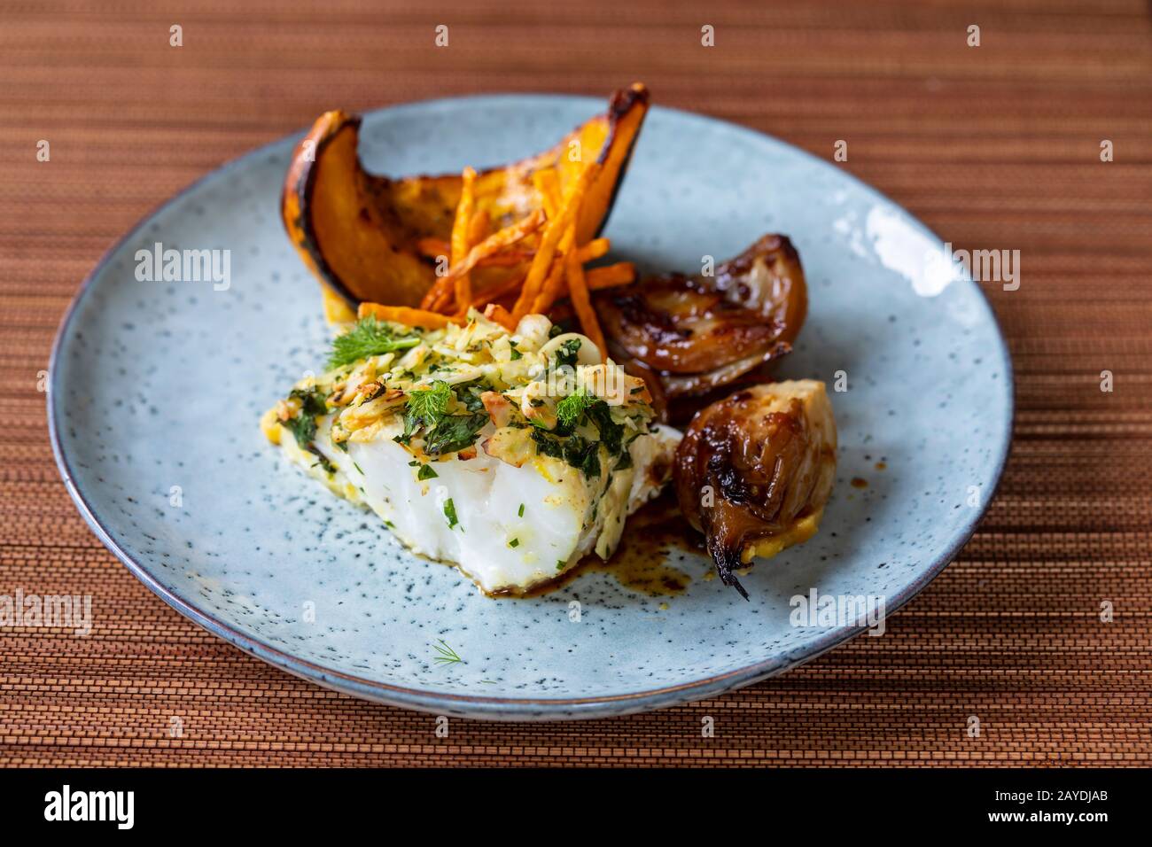 Cod loin in almond crust with pumpkin and fennel Stock Photo