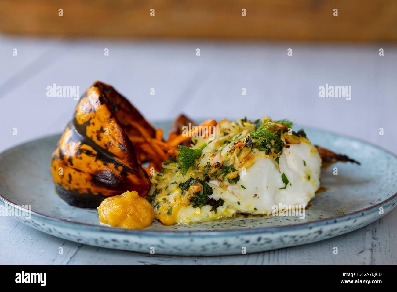 Cod loin in almond crust with pumpkin and fennel Stock Photo