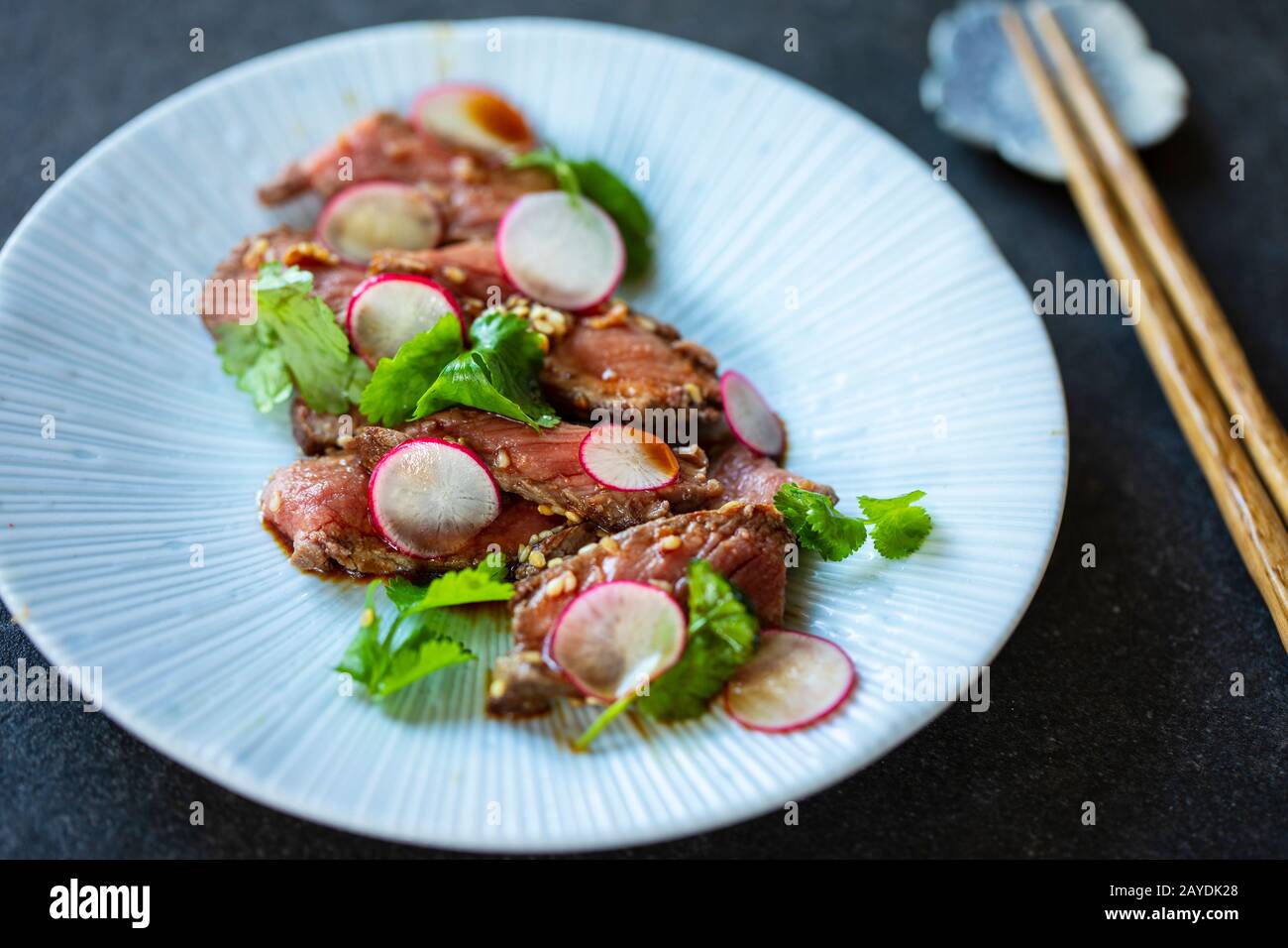 Japanese style beef tataki with radish and coriander Stock Photo Alamy