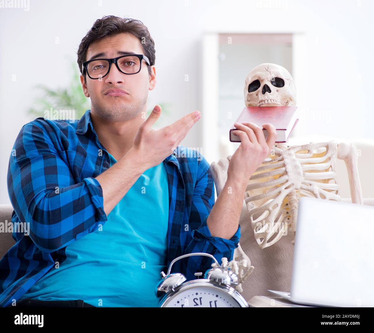 Student studying with skeleton preparing for exams Stock Photo