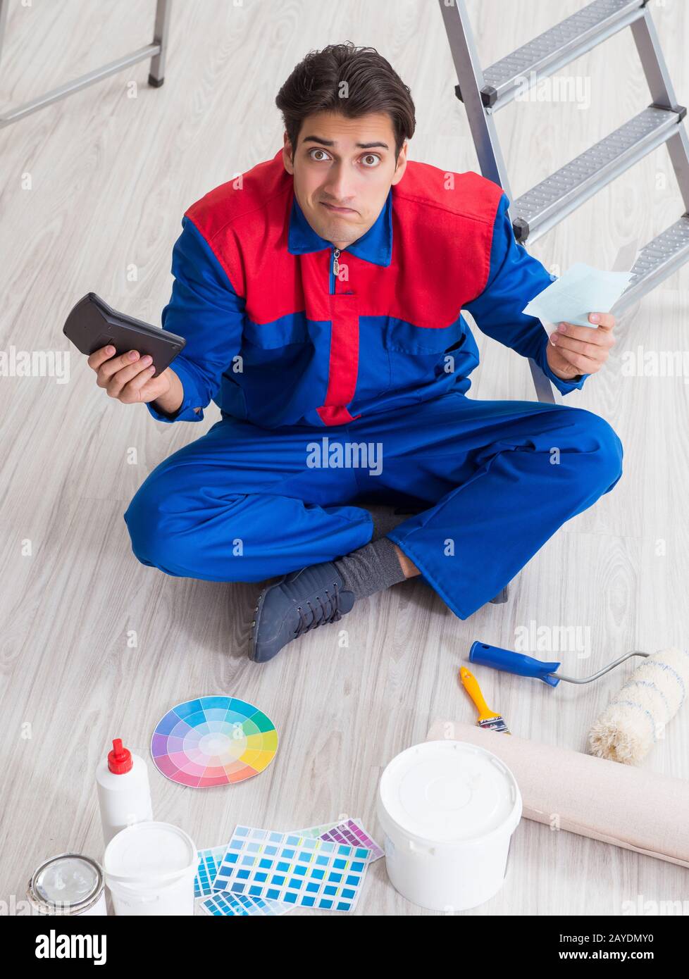 The young painter trying to match colours for painting job Stock Photo