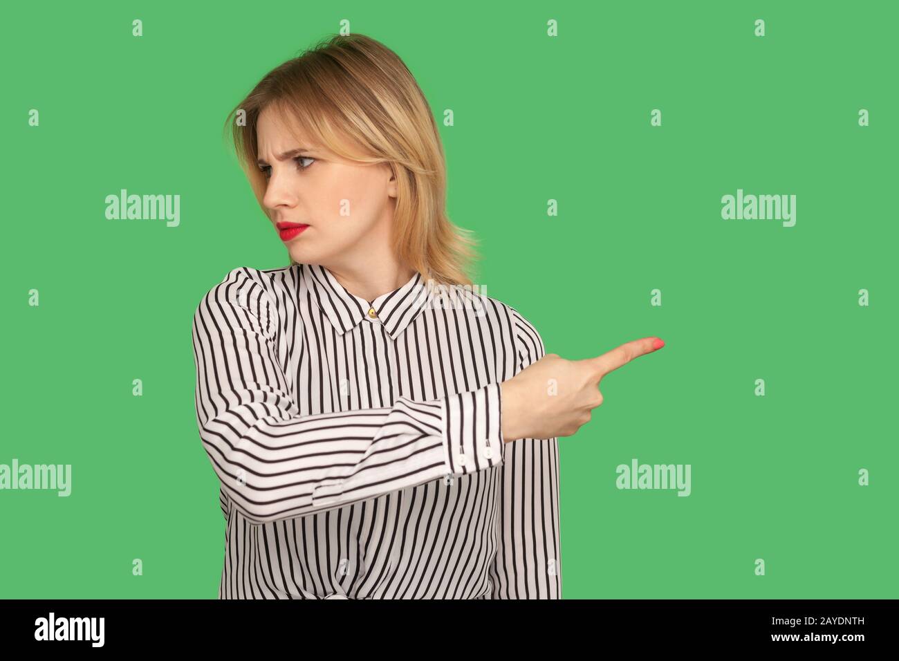 Get out! Dissatisfied annoyed woman with red lips in blouse showing way out with resentful irritated expression, ordering to leave, feeling betrayed. Stock Photo