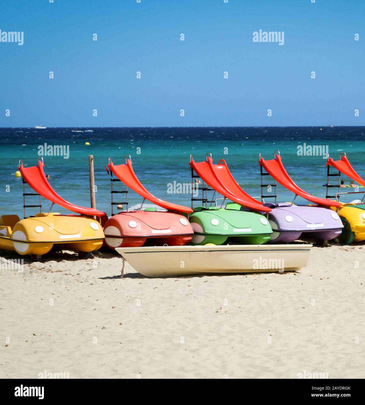 Pedal boats with slide lie on the beach Stock Photo Alamy