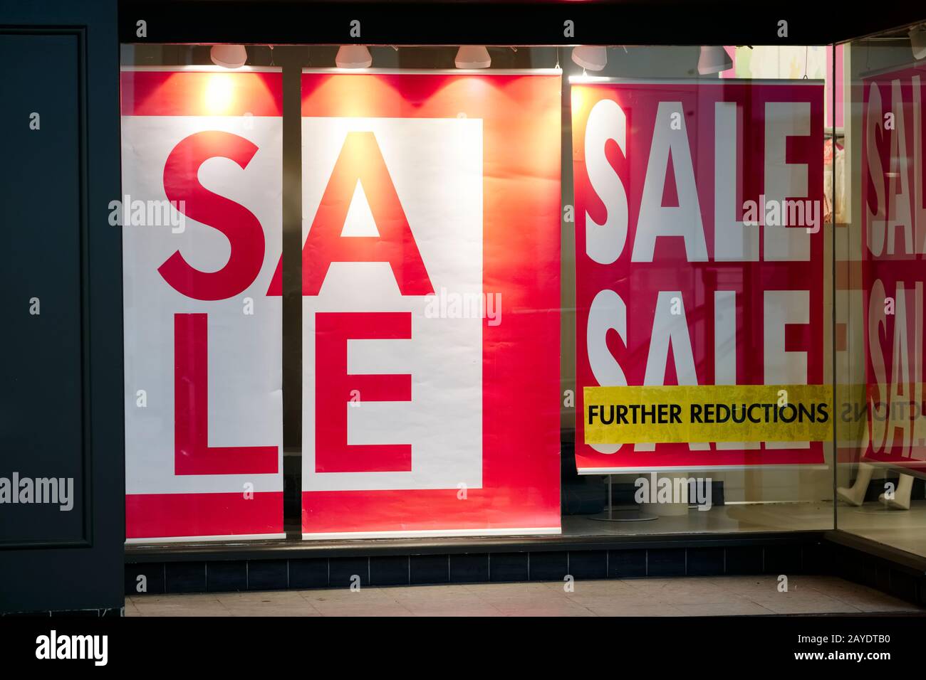 Closing down sale sign with further reductions and discount in shop ...