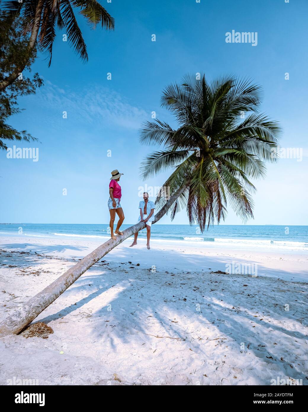 Wua Laen beach Chumphon area Thailand, palm tree hanging over the beach with couple on vacation in Thailand Asia Stock Photo