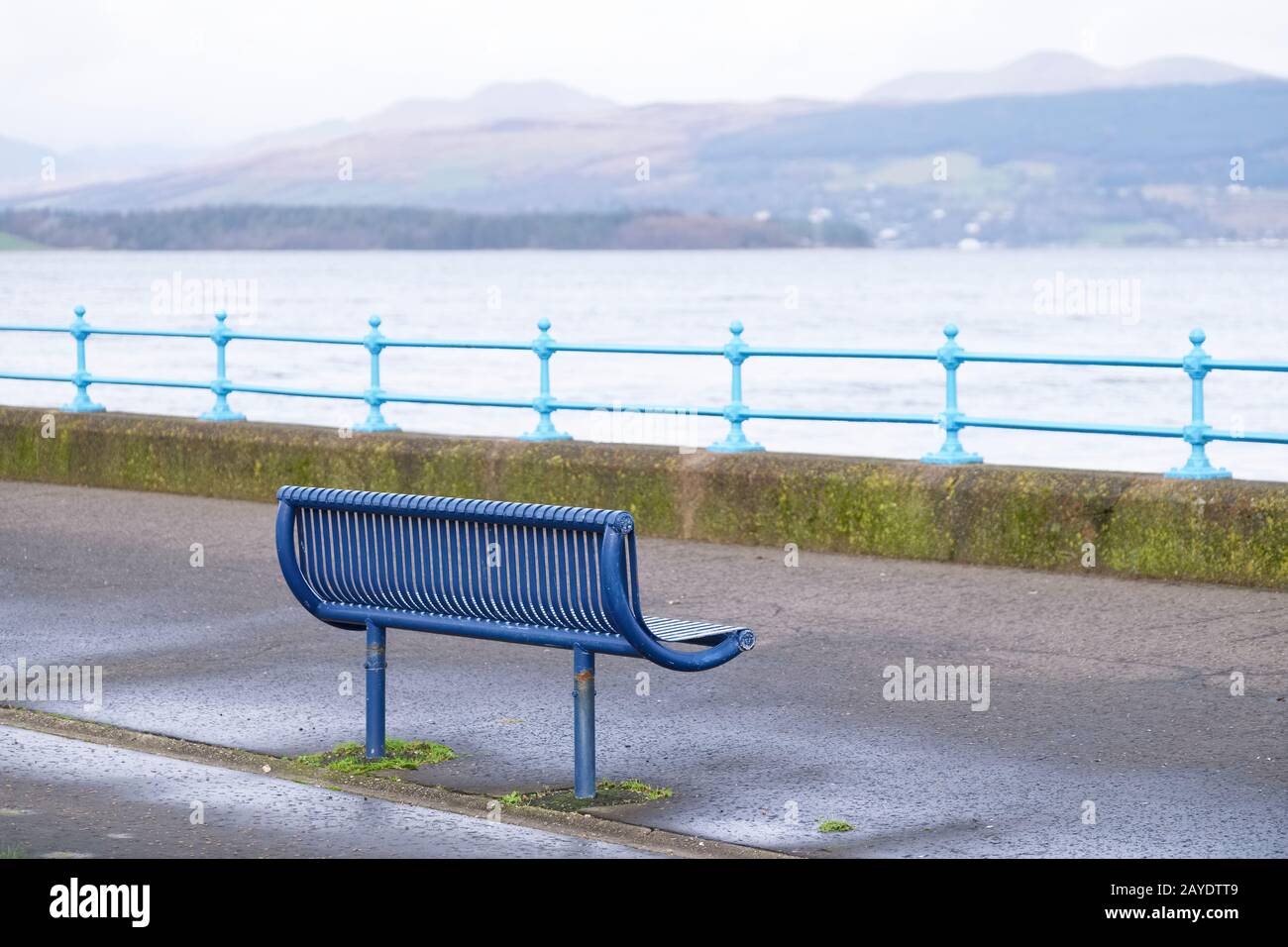 Lonely empty bench in open esplanade tranquil space on Scottish west coast town in Greenock Stock Photo