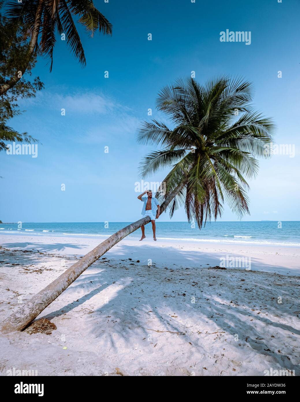 Wua Laen beach Chumphon area Thailand, palm tree hanging over the beach with guy on vacation in Thailand Asia Stock Photo