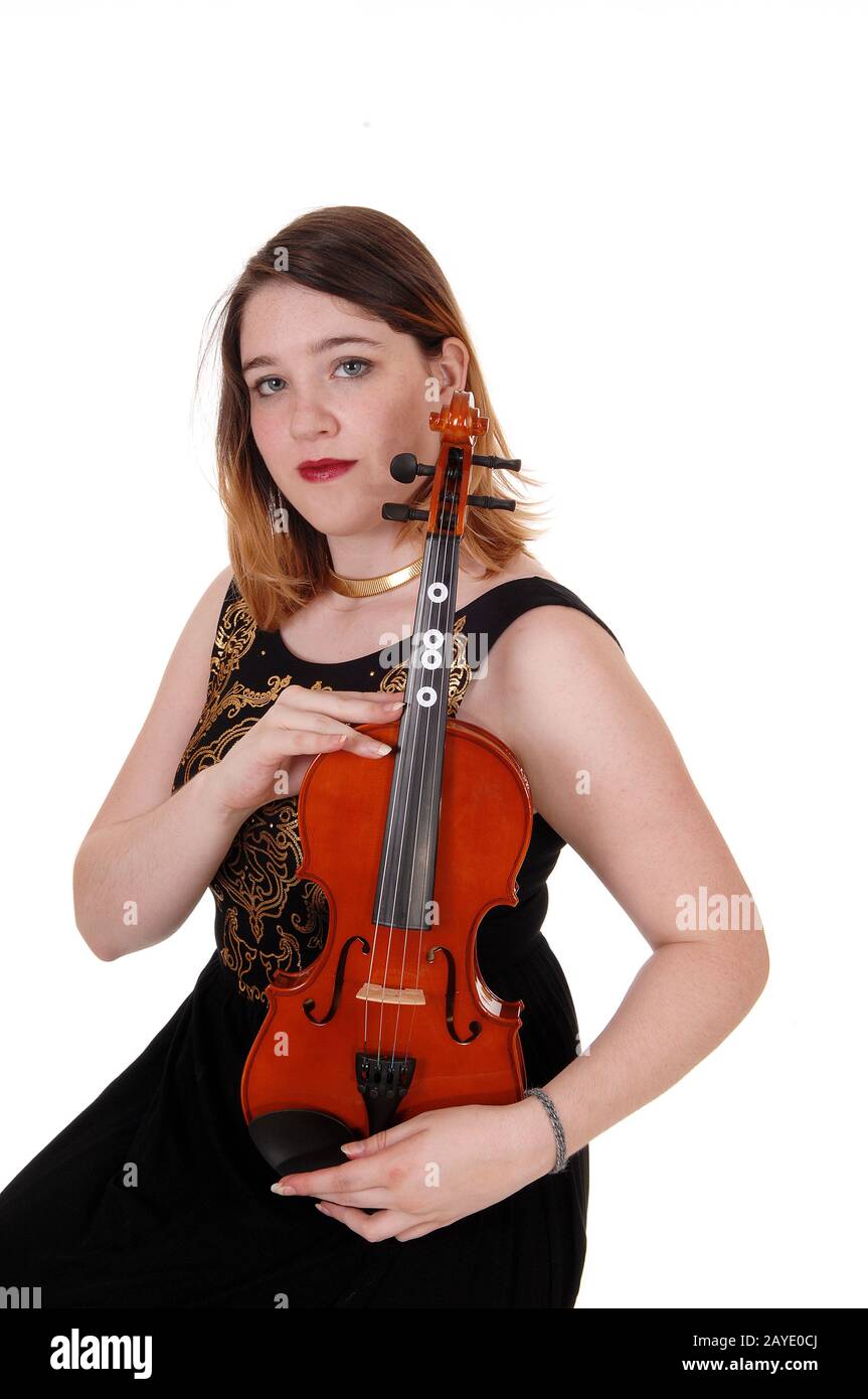 Woman sitting and holding her violin tight Stock Photo