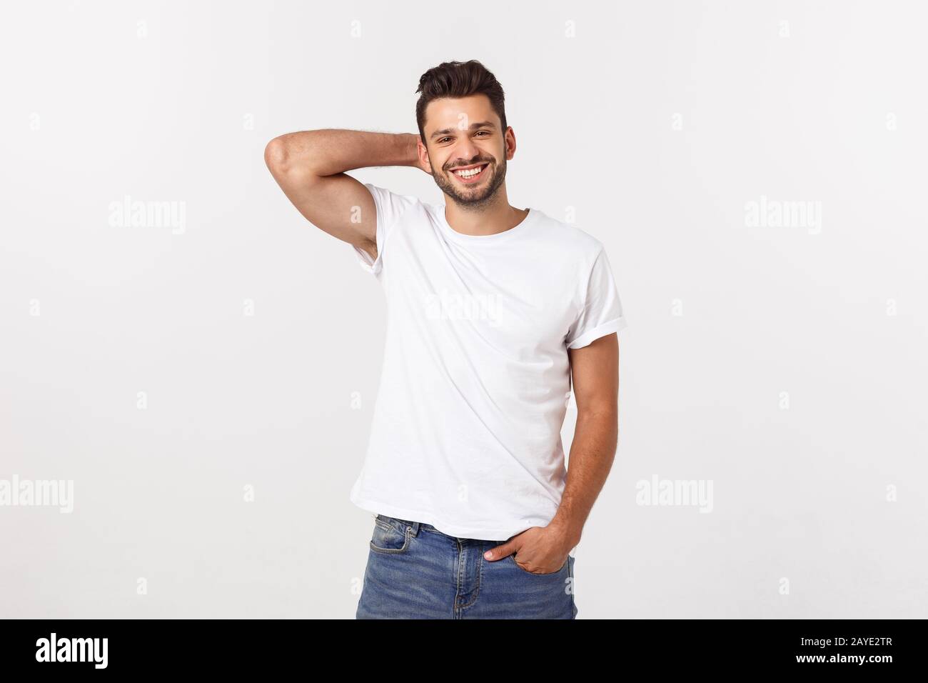 Portrait of a handsome young man smiling against white background Stock ...