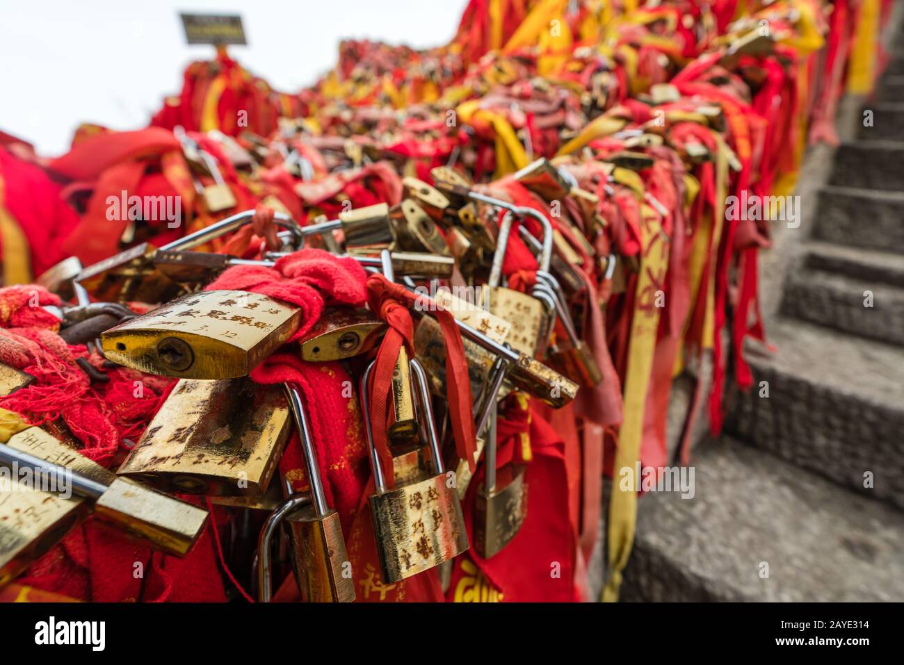 Red ribbons and padlocks along trail on Huashan Mountain Stock Photo