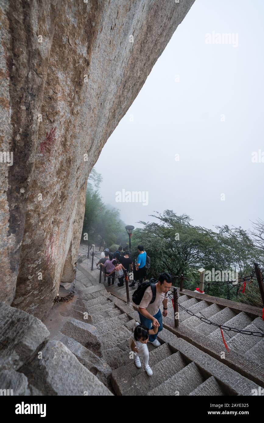 Tourists on steep mountain trail in Huashan mountain Stock Photo