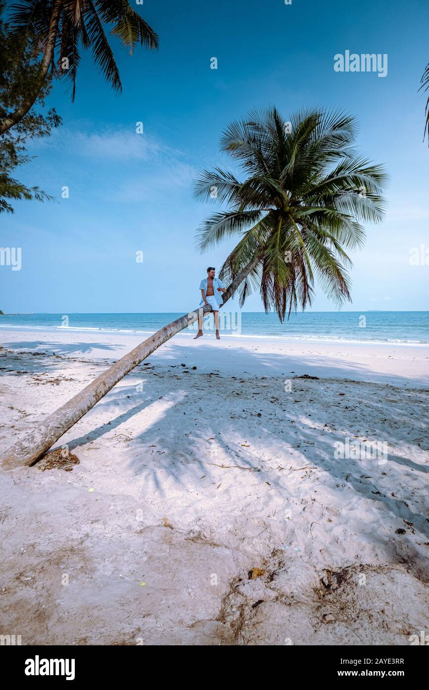 Wua Laen beach Chumphon area Thailand, palm tree hanging over the beach with guy on vacation in Thailand Asia Stock Photo